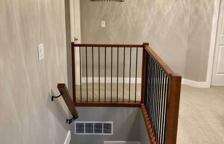 grey painted upstairs hallway with staircase leading down in an esquimalt home in victoria