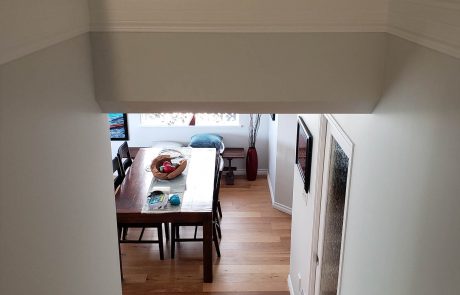 downward view of the dining room with light grey walls and white accent