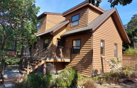 Brown and tanned house with a back patio