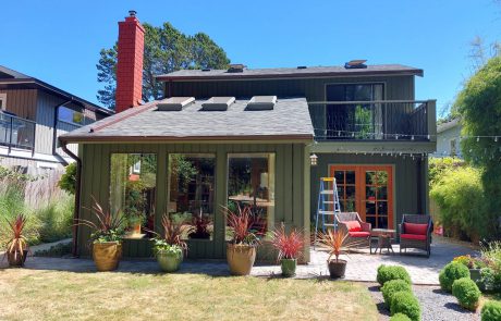 backyard and exterior of a painted Green house in Oak bay Victoria