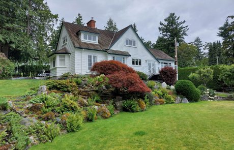 House with a lawn and landscaping in Arbutus Cove Victoria BC