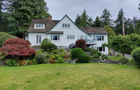 House with a lawn and landscaping in Arbutus Cove Victoria BC