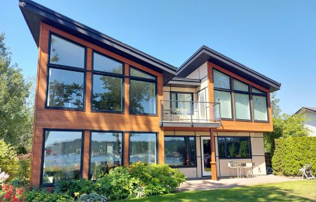 modern house with slanted black roofing and glass windows in sidney victroria