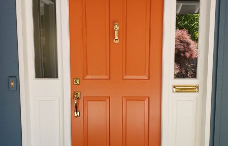 Bold orange painted door of a Blue home in Uplands Victoria