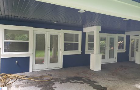 bottom level of a house painted blue with white accents, in view royal victoria