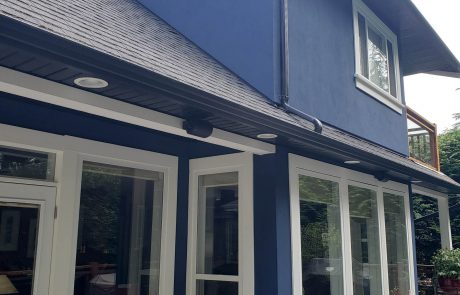 side of the royal blue painted house with white window frames in view royal victoria