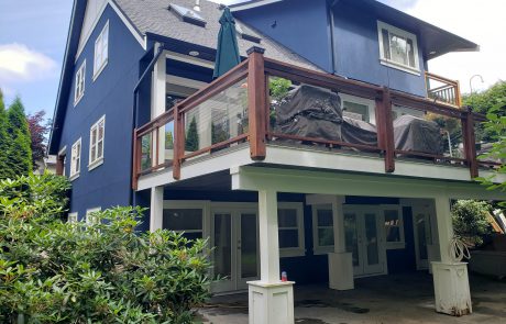 back of a 3-story royal blue house with a back deck in view royal victoria