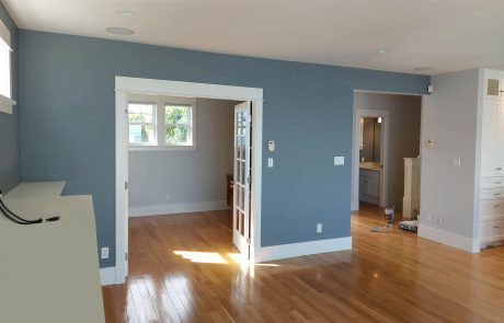 open concept living room with dark grey walls in an oak bay home