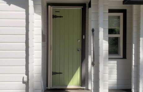 Light green painted entrance door of a white house in Panabode Victoria