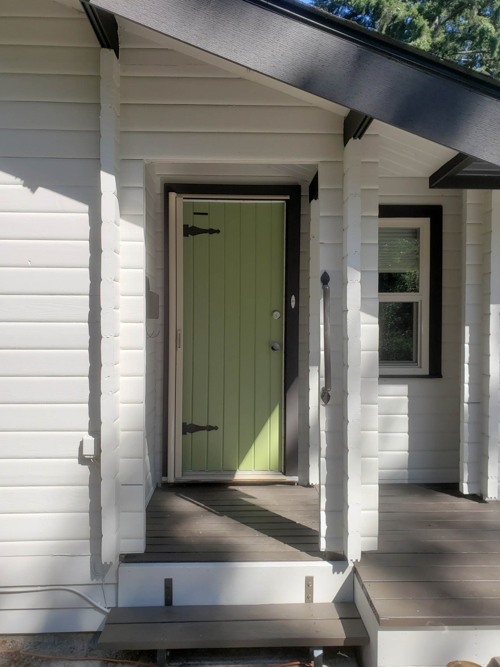 Light green painted entrance door of a white house in Panabode Victoria