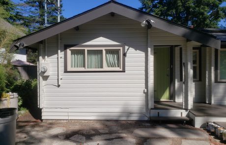 front view of a white house with black window frames in Panabode Victoria