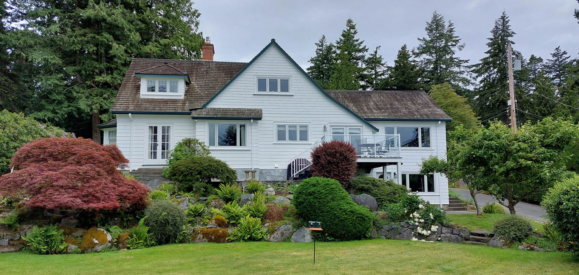 Arbutus cove white house with landscaped garden
